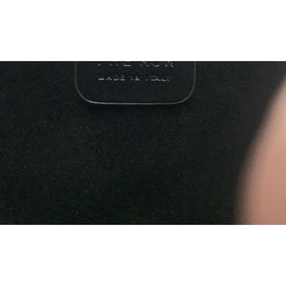 The Row half moon handbag in black.